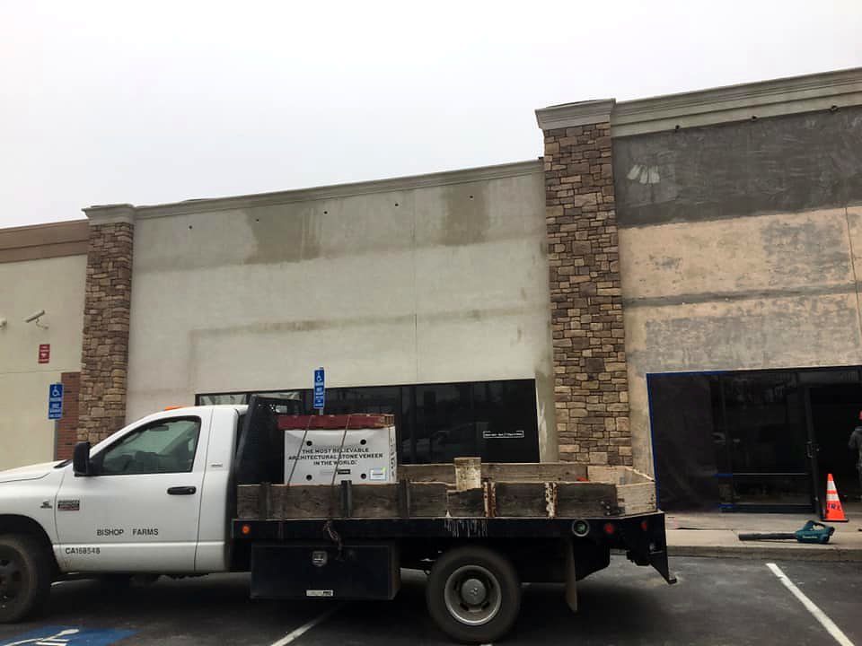 Commercial stone veneer installation on retail building by Warrens Masonry